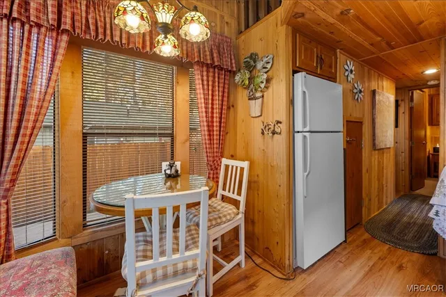 a view of a balcony with furniture and wooden floor