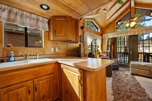 a spacious bathroom with a tub a sink and a large mirror