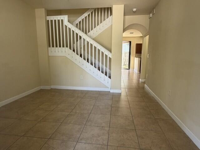 23765 Southwest 118 Avenue, Unit 23765 Homestead, FL 33032 - Photo 4 of 36 a view of staircase with white walls and railing