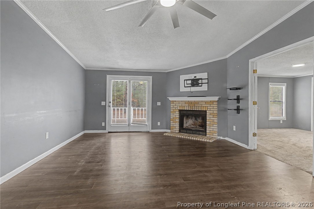 1512 Seabrook School Road Fayetteville, NC 28312 - Photo 7 of 30 a view of an empty room with wooden floor fireplace and a window