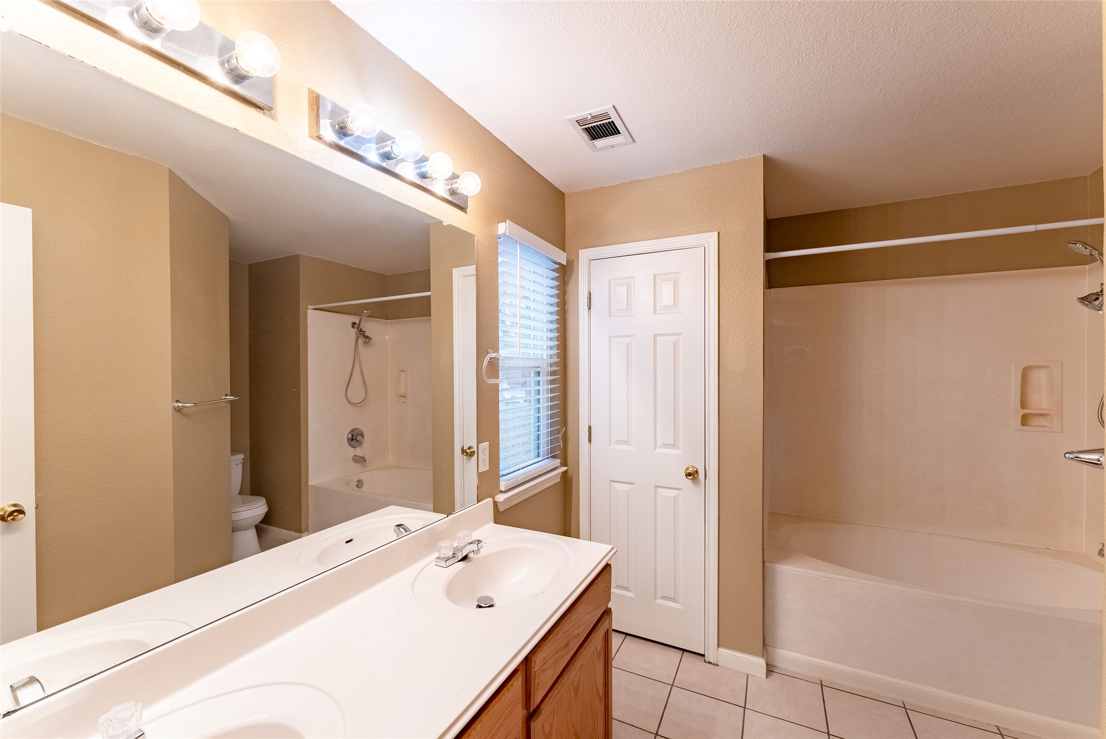 109 Granite Shoals Drive Kyle, TX 78640 - Photo 15 of 22 a bathroom with a bathtub and a shower