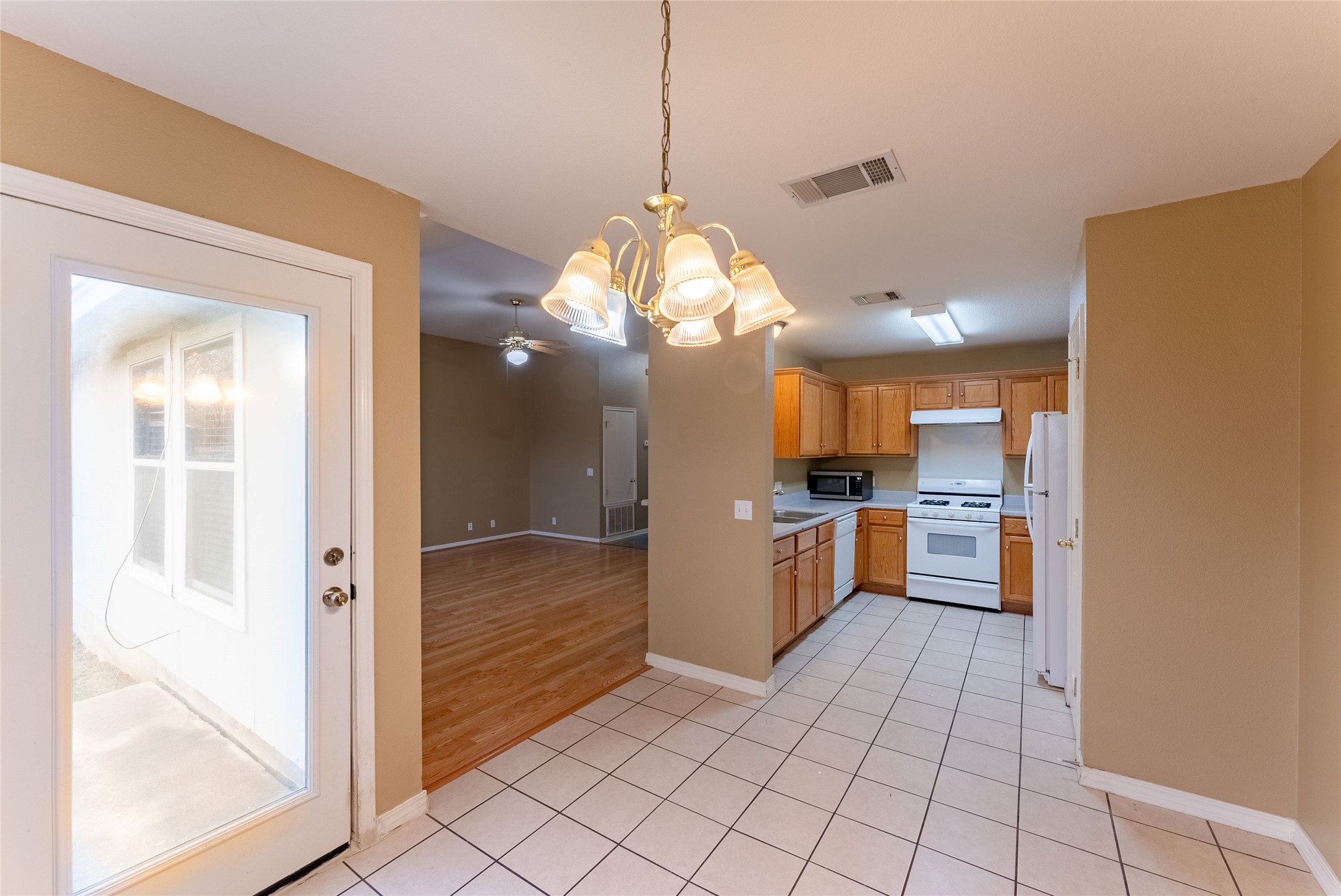 109 Granite Shoals Drive Kyle, TX 78640 - Photo 17 of 22 a view of a hallway with kitchen and dining room view