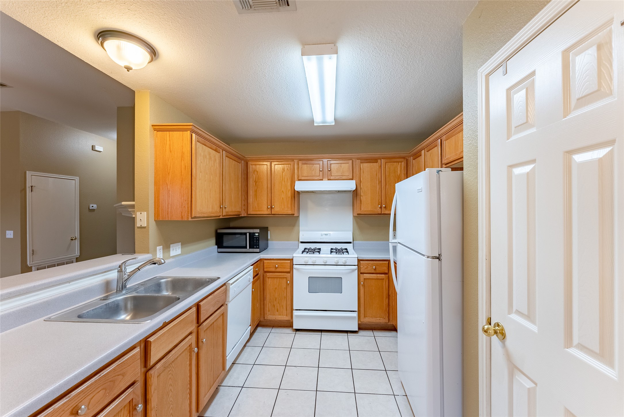 109 Granite Shoals Drive Kyle, TX 78640 - Photo 18 of 22 a kitchen with a refrigerator a sink and dishwasher