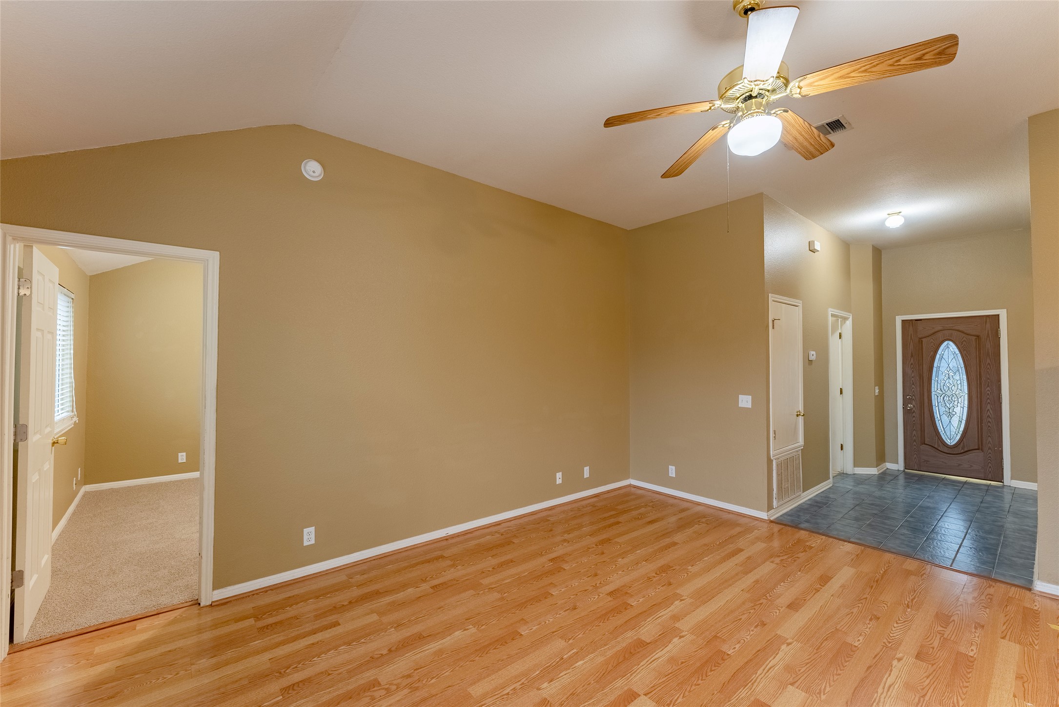 109 Granite Shoals Drive Kyle, TX 78640 - Photo 4 of 22 wooden floor in an empty room with a window