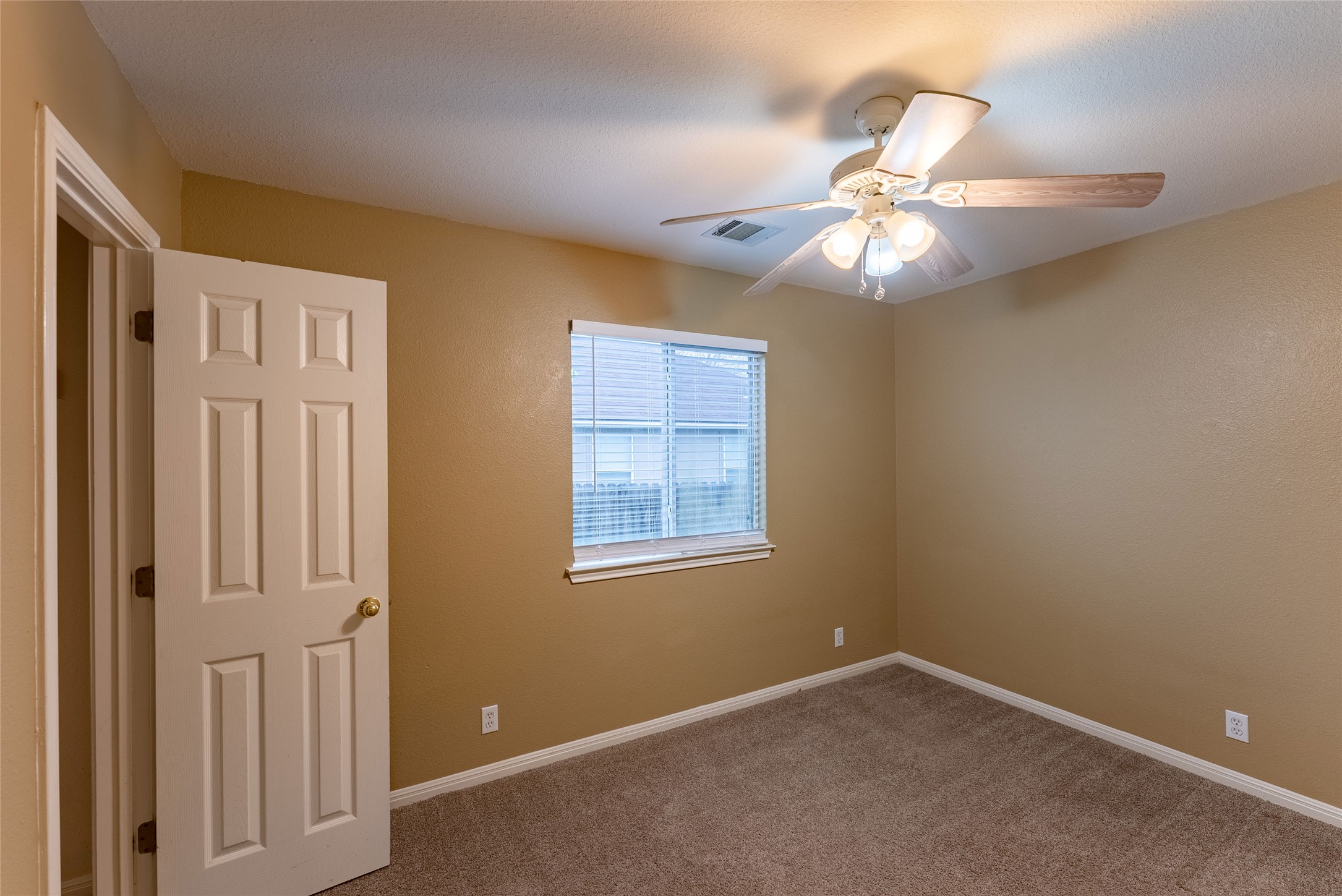 109 Granite Shoals Drive Kyle, TX 78640 - Photo 7 of 22 an empty room with windows and fan