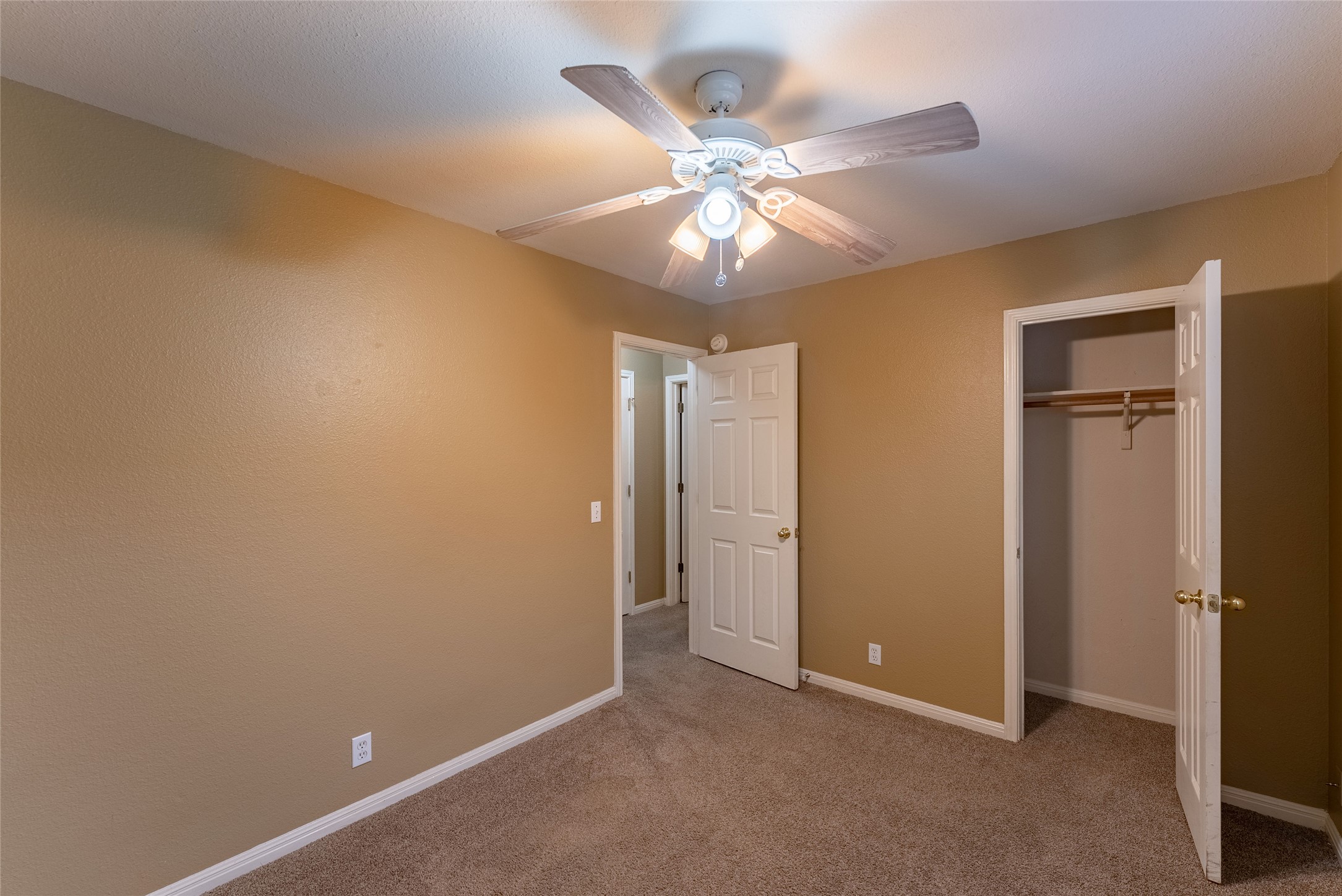 109 Granite Shoals Drive Kyle, TX 78640 - Photo 8 of 22 an empty room with a ceiling fan and a window