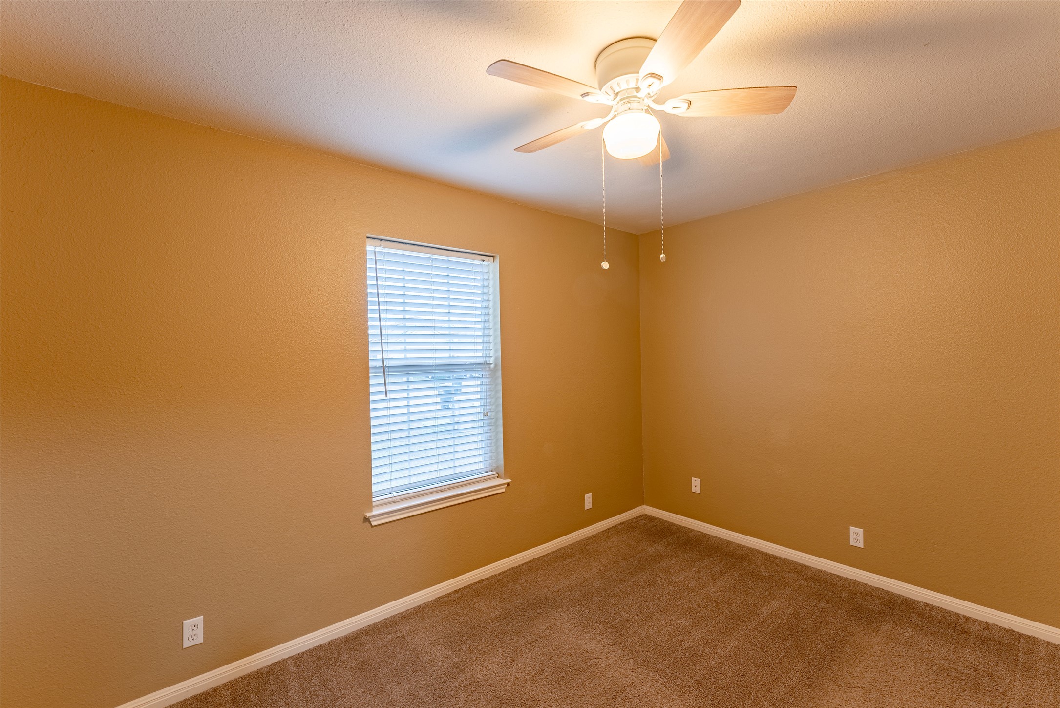 109 Granite Shoals Drive Kyle, TX 78640 - Photo 9 of 22 an empty room with a window and a ceiling fan