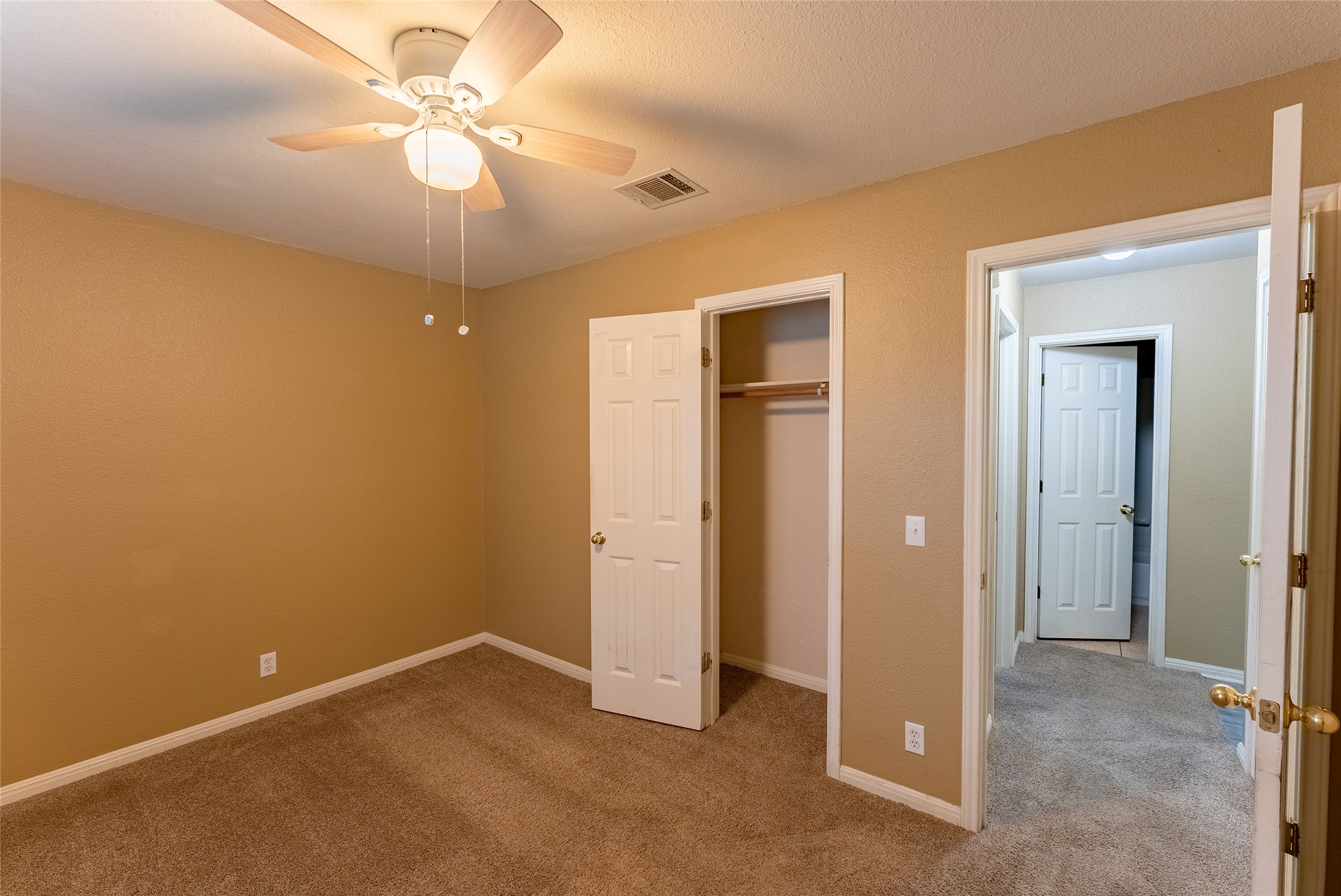 109 Granite Shoals Drive Kyle, TX 78640 - Photo 10 of 22 an empty room with closet and a chandelier fan