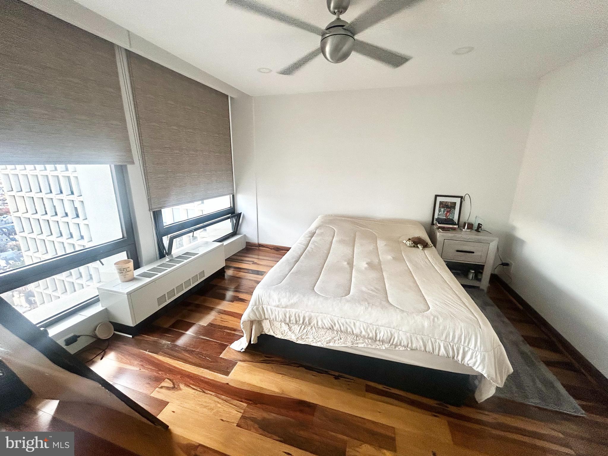 200 Locust Street, Unit 27H Philadelphia, PA 19106 - Photo 4 of 9 a bedroom with a bed and a window