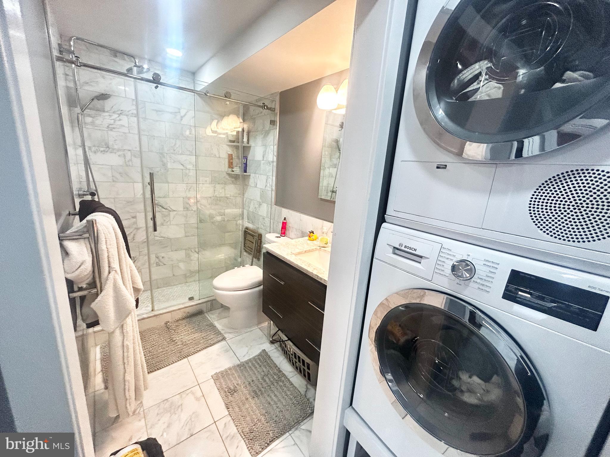 200 Locust Street, Unit 27H Philadelphia, PA 19106 - Photo 7 of 9 a living room with furniture and a mirror