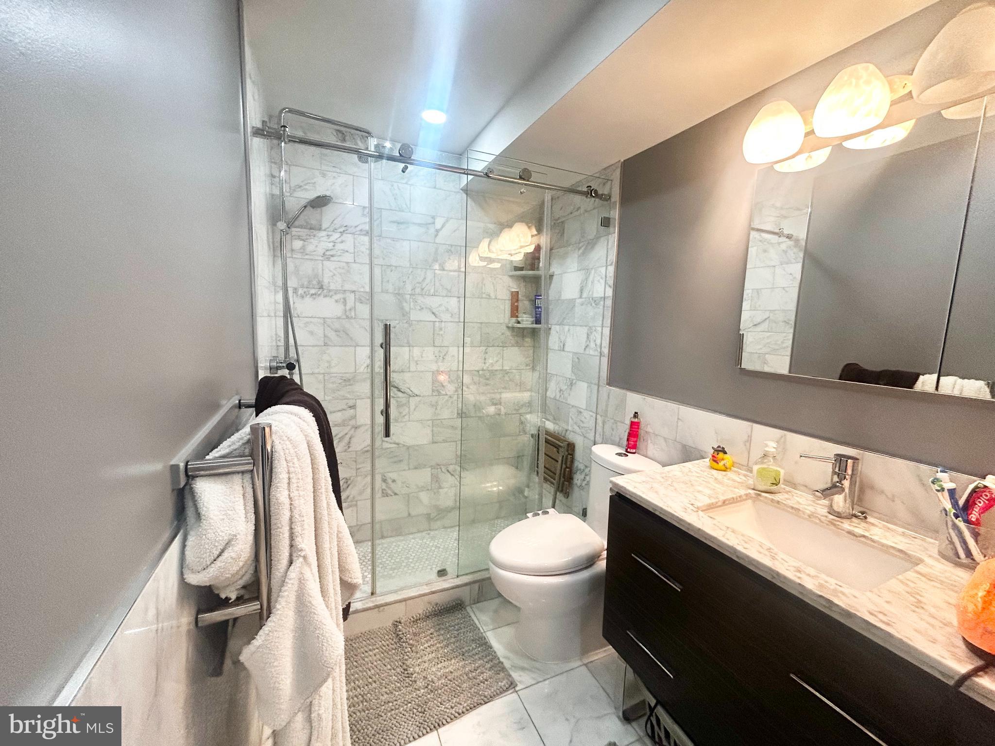 200 Locust Street, Unit 27H Philadelphia, PA 19106 - Photo 8 of 9 a bathroom with a sink toilet and shower