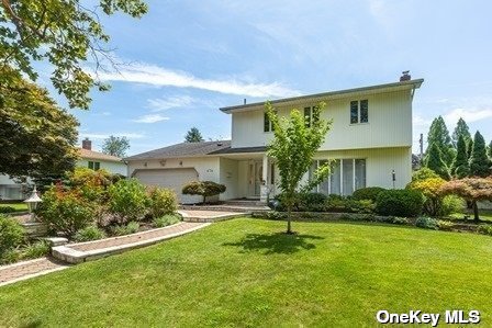 474 South Marginal Road Jericho, NY 11753 - Photo 1 of 1 a front view of a house with garden