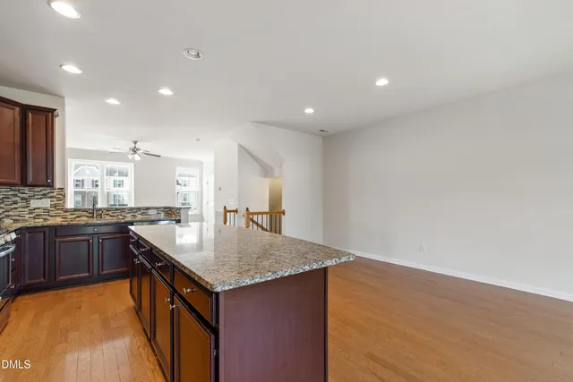 a kitchen with granite countertop sink stove and refrigerator