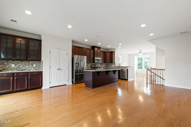 a large kitchen with a table and chairs in it