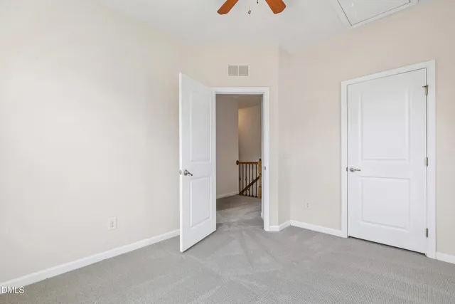 an empty room that has a wooden cupboard