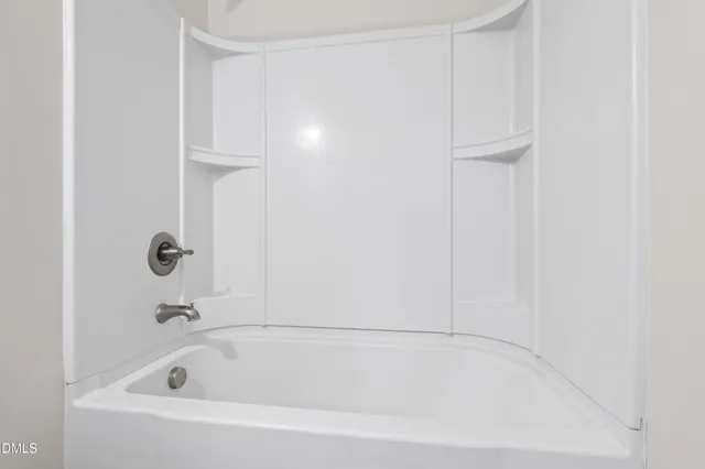 a white bath tub sitting in a bathroom