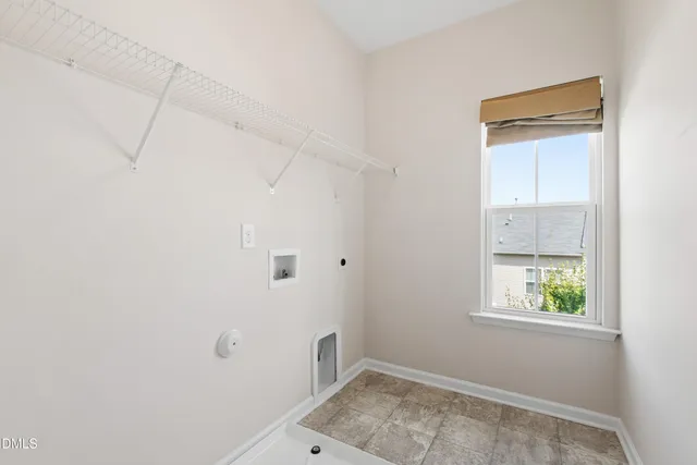 an empty room with a window and wooden floor