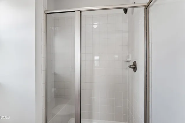 a bathroom with a glass shower door