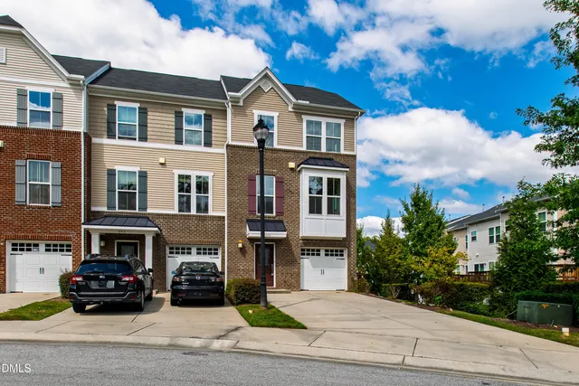 a car parked in front of a white building