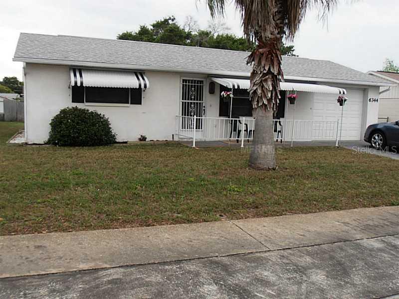 6344 Sutherland Avenue New Port Richey, FL 34653 - Photo 1 of 1 a front view of a house with garden