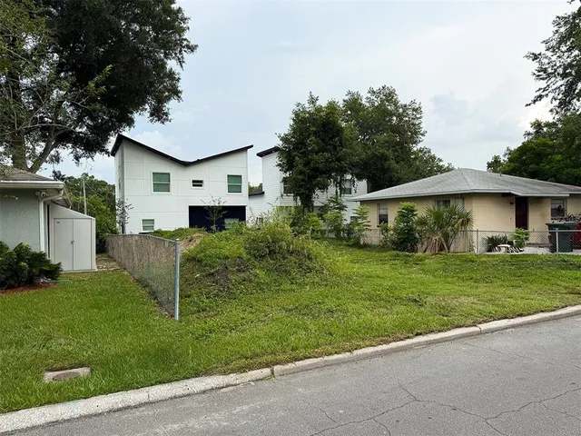a front view of house with a garden