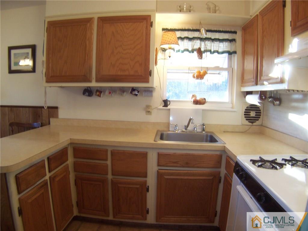 169 North Hill Road Colonia, NJ 07067 - Photo 3 of 19 a kitchen with a sink a stove and cabinets