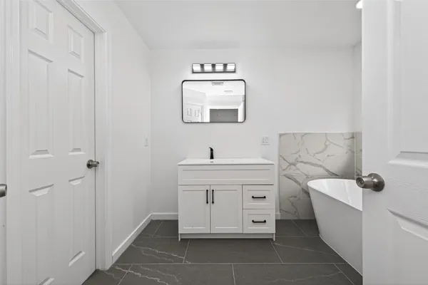 a bathroom with a toilet a sink and mirror