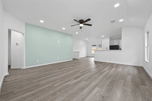 a view of a kitchen with a dishwasher and wooden floor