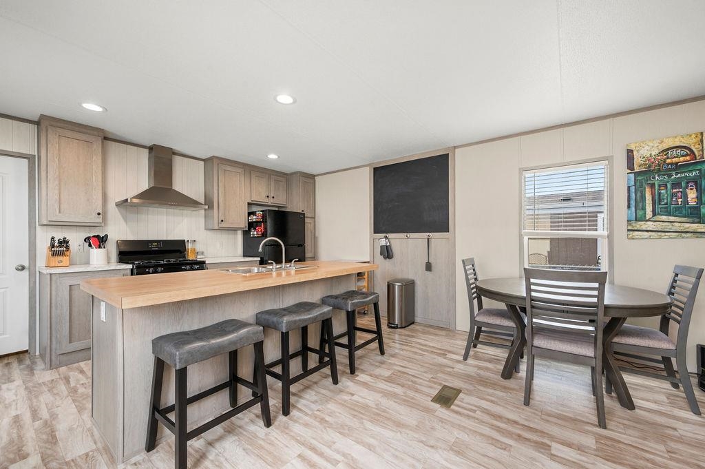 271 Clements Way Fruita, CO 81521 - Photo 5 of 26 a kitchen with stainless steel appliances a table chairs sink and cabinets
