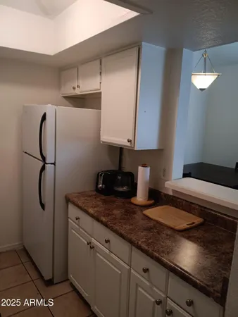a kitchen with granite countertop a sink and a stove