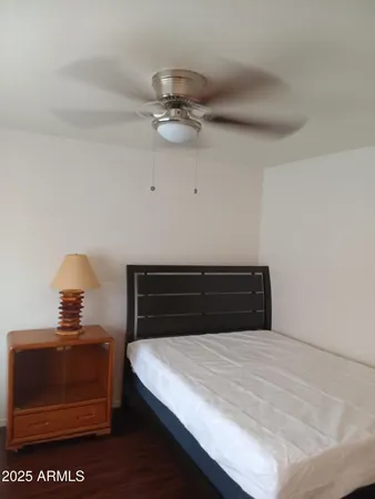 a large bed sitting in a bedroom next to a window