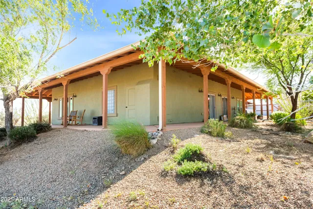 a view of a house with a yard and tree