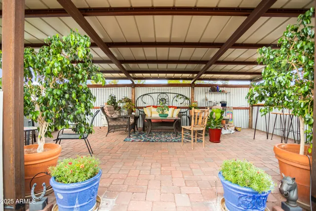 a living room with furniture a fireplace and a large window