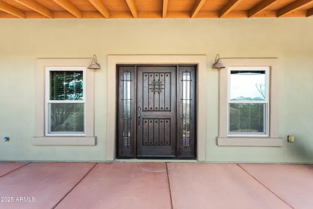 a view of swimming pool with lawn chairs and plants