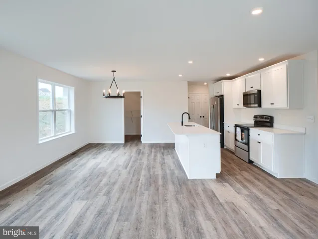 a view of kitchen with wooden floor and electronic appliances