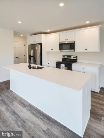 a kitchen with stainless steel appliances a microwave a sink and a refrigerator