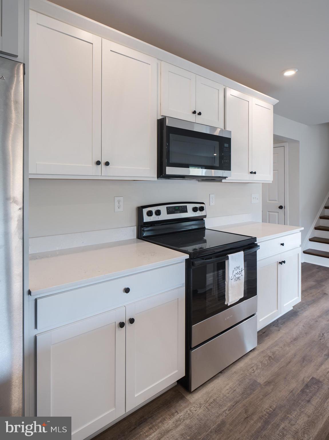 307 Boxwood Drive Windsor, PA 17366 - Photo 14 of 43 a kitchen with stainless steel appliances granite countertop white cabinets a sink a stove and a refrigerator