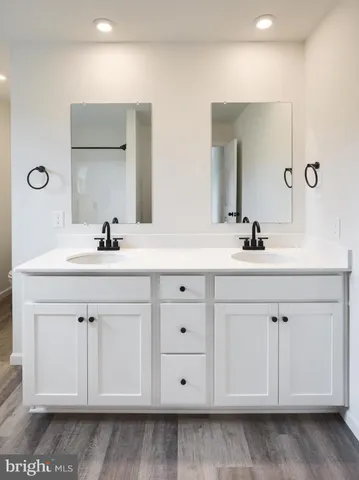 a bathroom with a double vanity sink and mirror