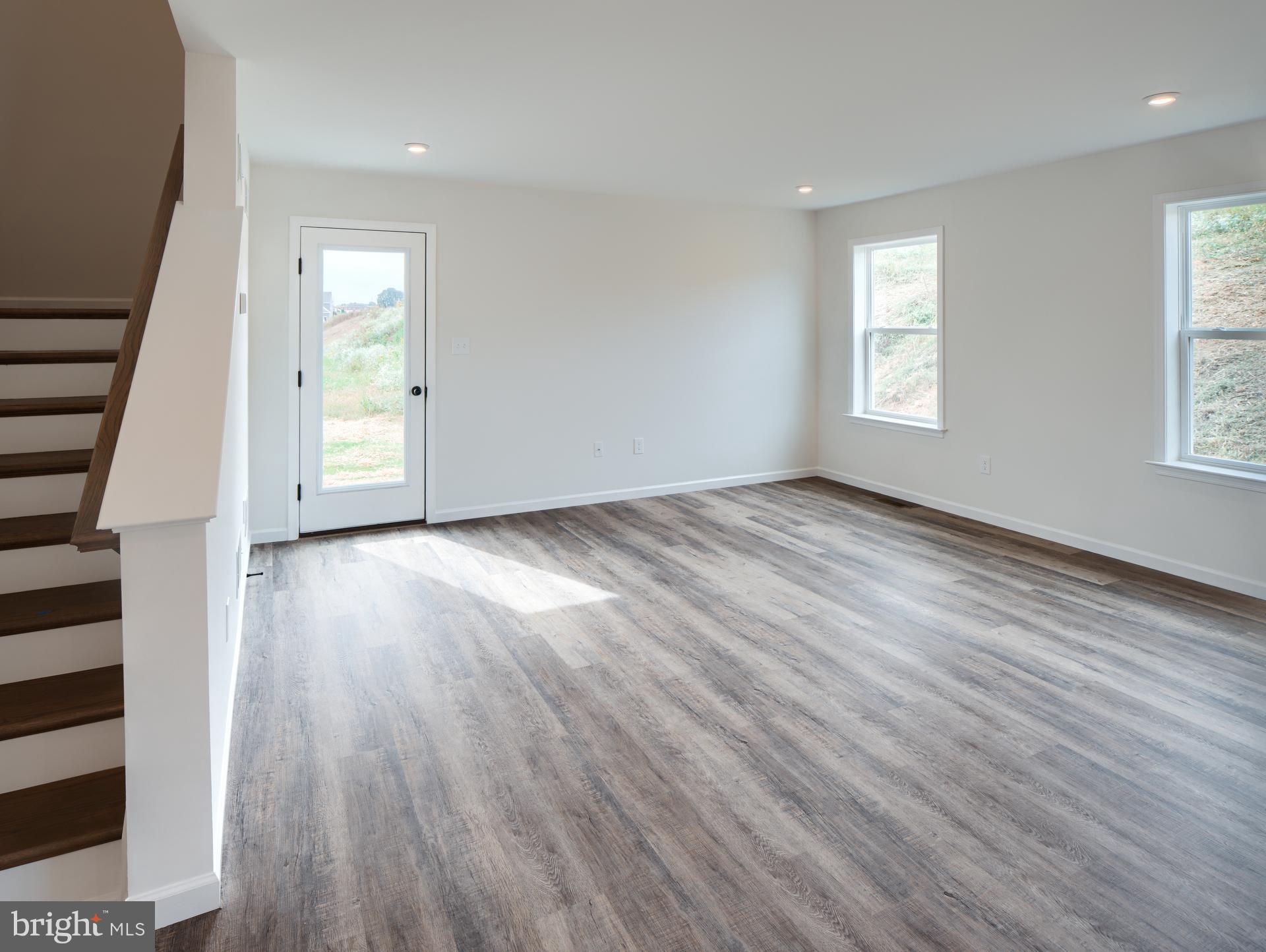 307 Boxwood Drive Windsor, PA 17366 - Photo 4 of 43 an empty room with wooden floor and windows