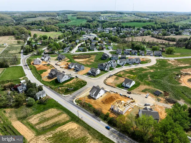 an aerial view of a residential houses with outdoor space