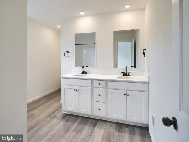 a bathroom with double vanity sink a mirror and vanity