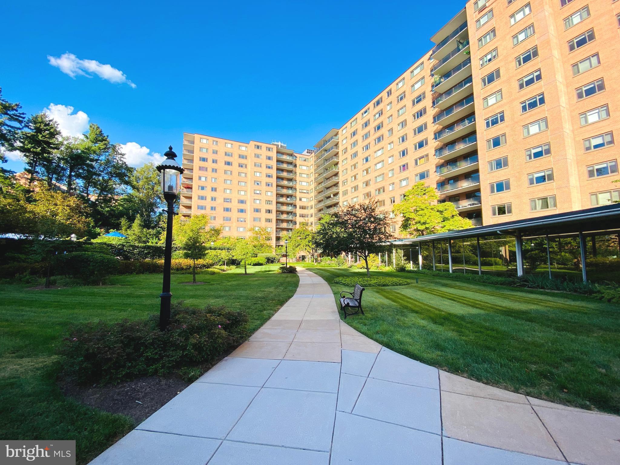 a view of a big building with a big yard and potted plants