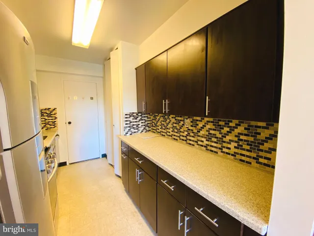 a kitchen with a refrigerator and a stove
