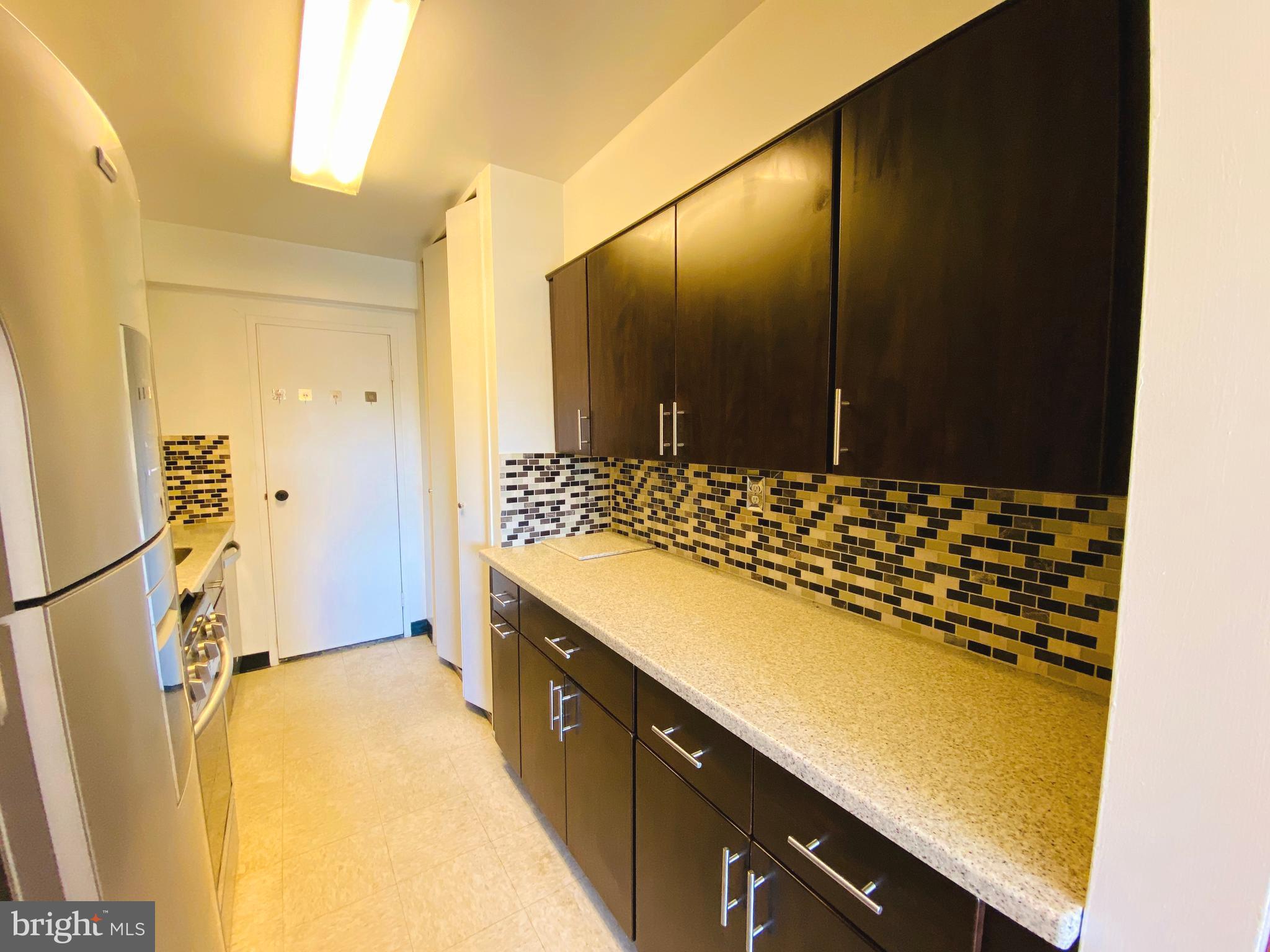 4201 Cathedral Avenue Northwest, Unit 622E Washington, DC 20016 - Photo 12 of 34 a bathroom with a sink and a mirror