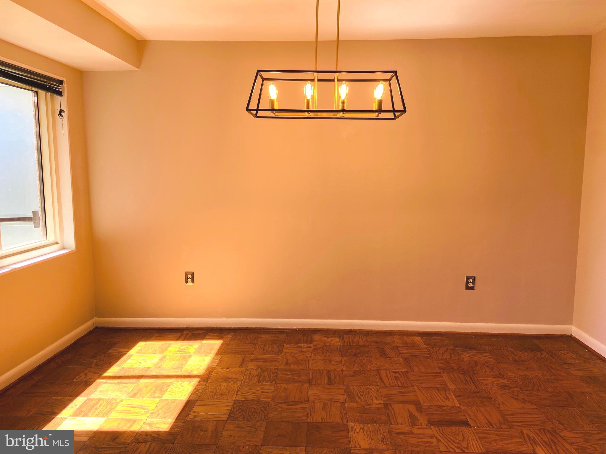 4201 Cathedral Avenue Northwest, Unit 622E Washington, DC 20016 - Photo 15 of 34 a view of a room with wooden floor and white walls