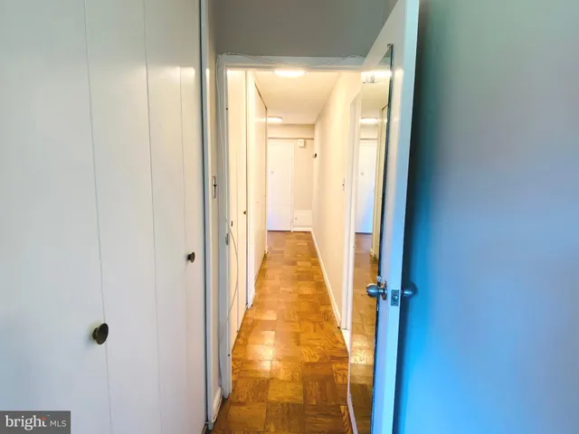 a view of hallway with wooden floor