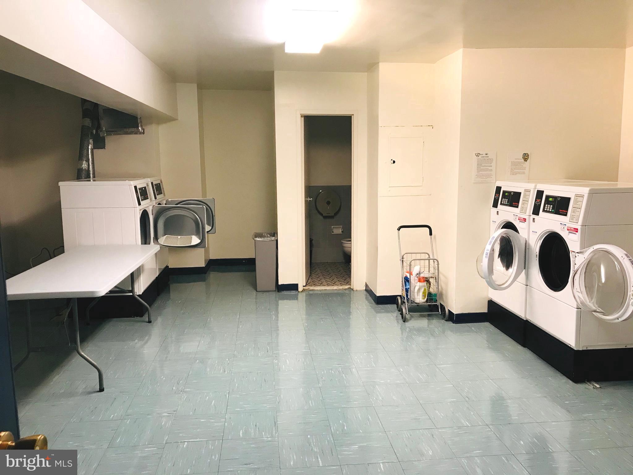 4201 Cathedral Avenue Northwest, Unit 622E Washington, DC 20016 - Photo 29 of 34 a living room with a chair and white walls