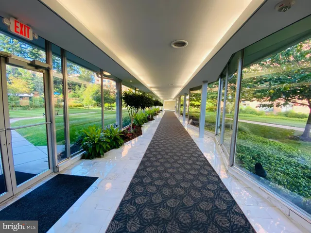 a view of a hallway with furniture