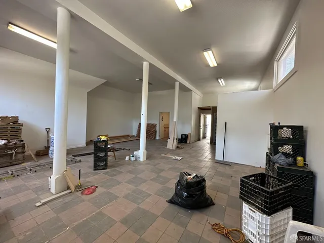 a living room with furniture a dining table and chairs