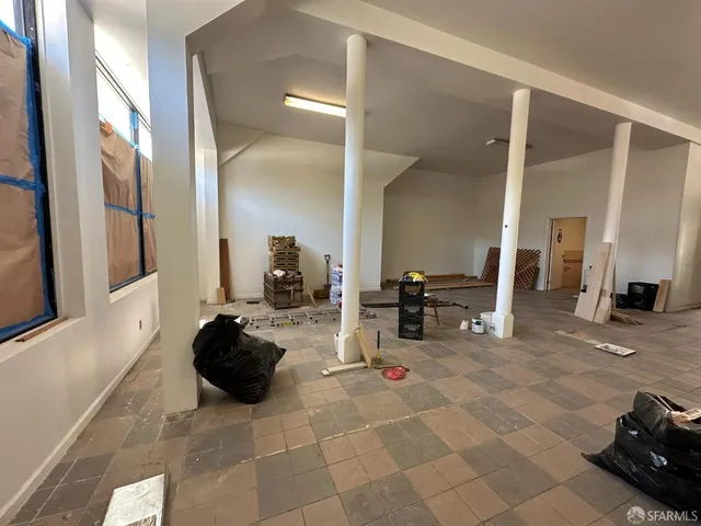 a view of a room with gym equipment and a large window